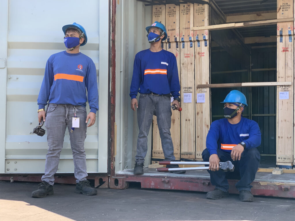 Three Toplis Solutions employees wearing construction outfits with the company logo