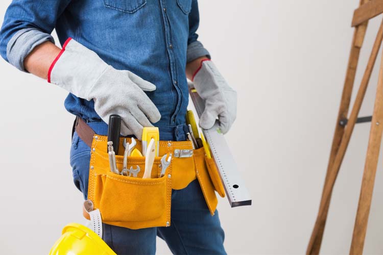 property maintenance worker carrying tools at his waist