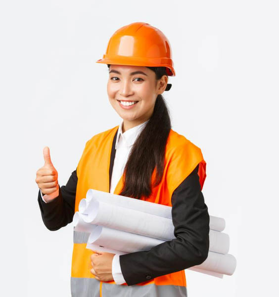 construction manager, wearing a yellow hard hat and a safety vest, holding plans and giving a thumbs-up gesture