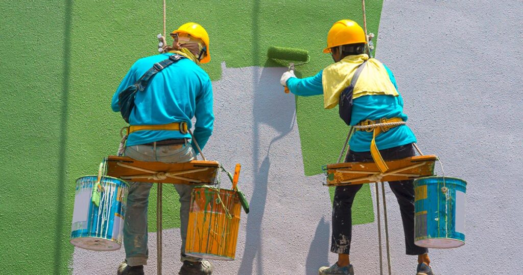 Building maintenance team painting a wall
