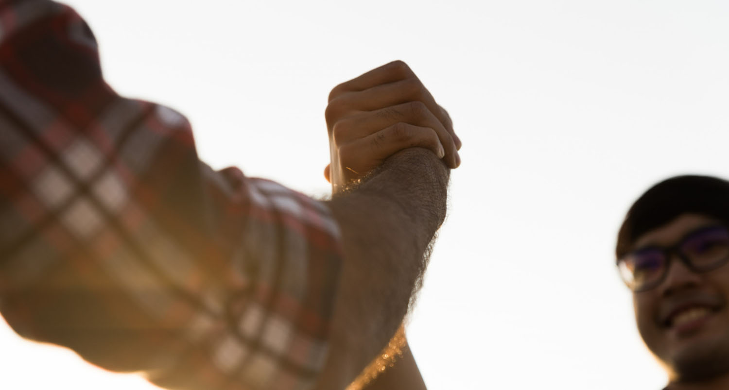 Two businessmen shaking hands outdoors