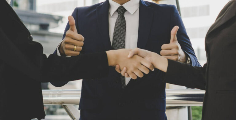 business people shaking hands, man thumbs up