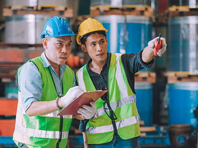 warehouse supervisor teaching a new guy in a warehouse