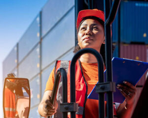 woman wearing safety vest, holds a checklist colored blue, logistics and trasport