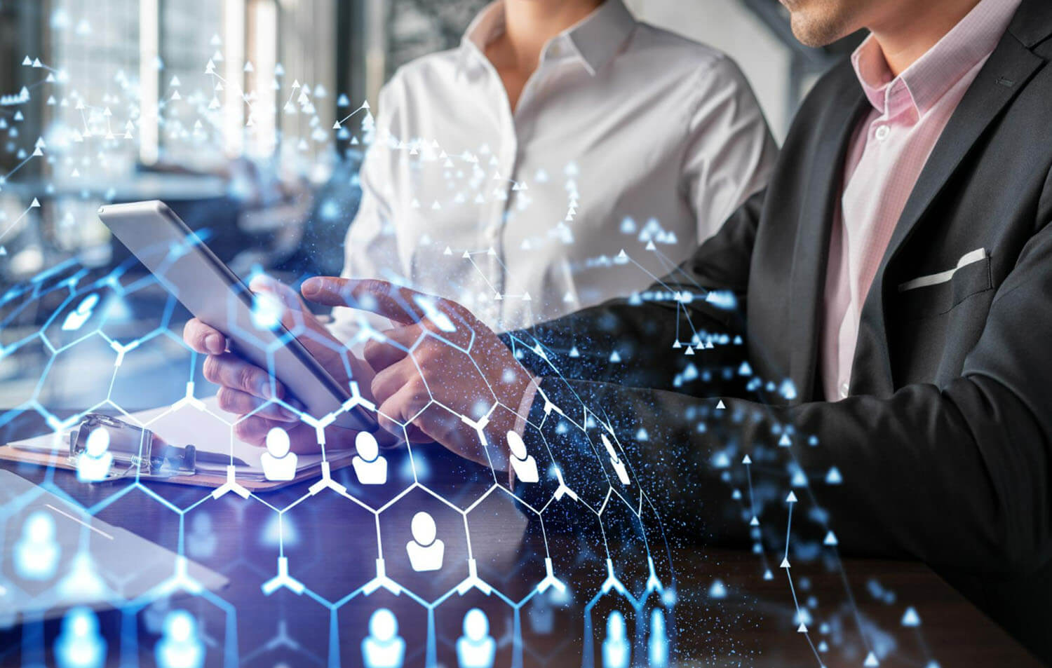 man holds a tablet, and a woman wears white, futuristic background