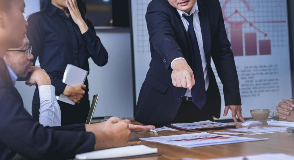 team leader is showing a paper to their office mate