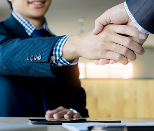 young man from a manpower service provider company is shaking hands with his business partner