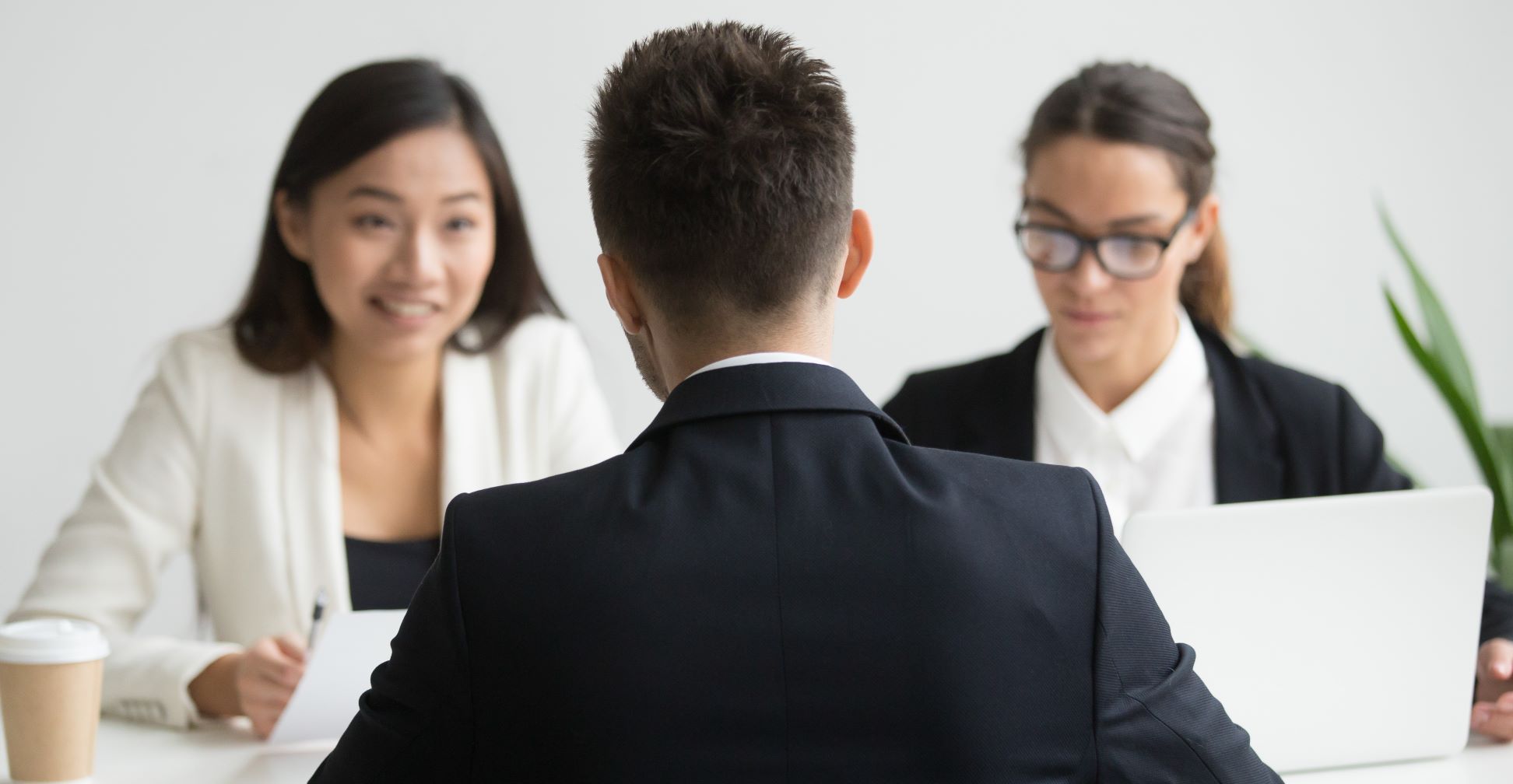 A male candidate being interviewed by diverse HR team in a service contracting company