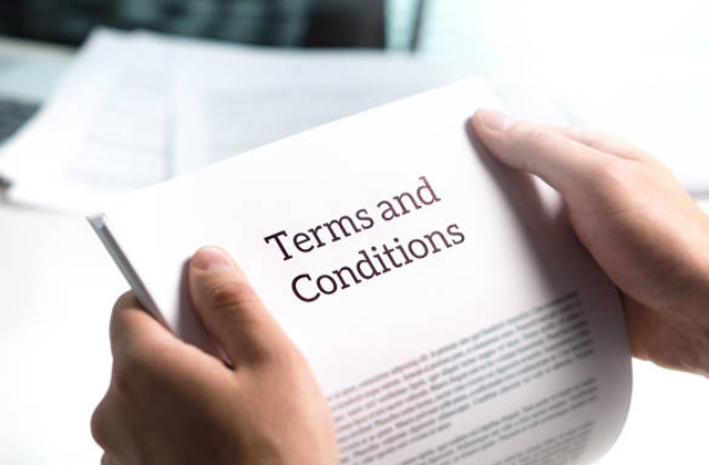 man holding contract reading terms and conditions