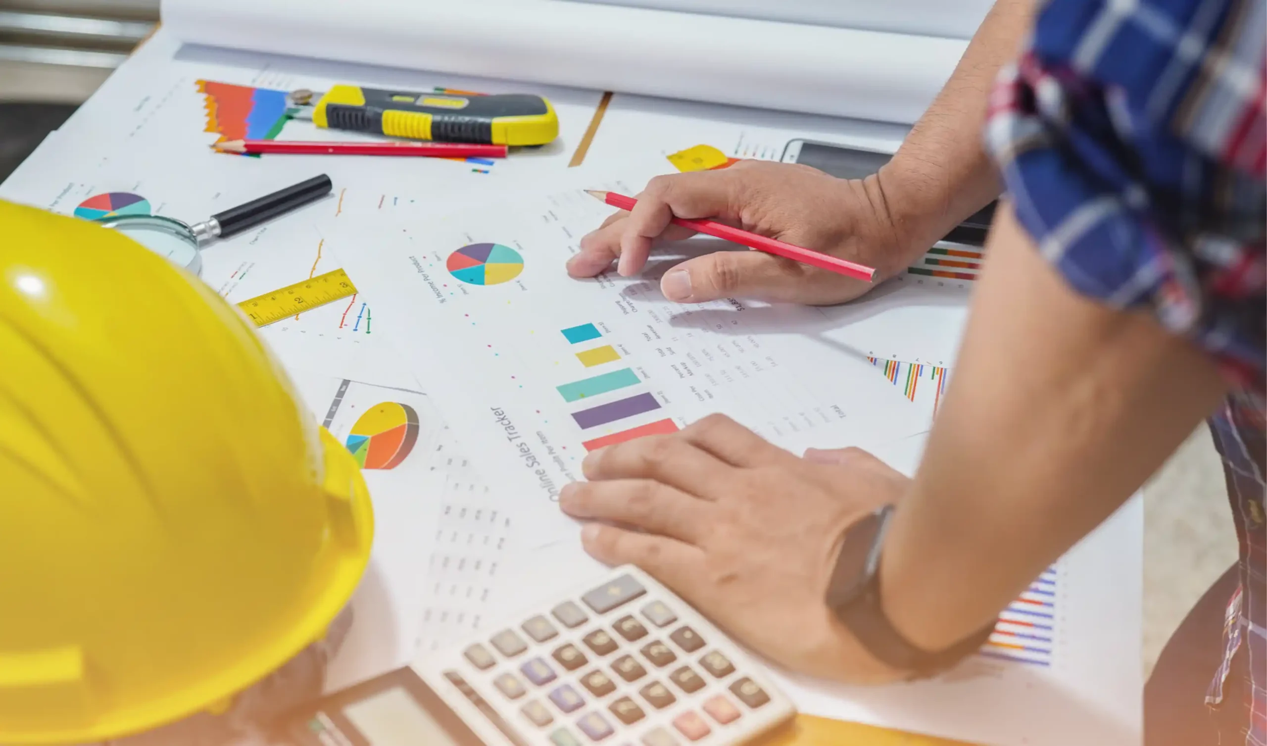 Planner reviewing cost data at a cluttered desk